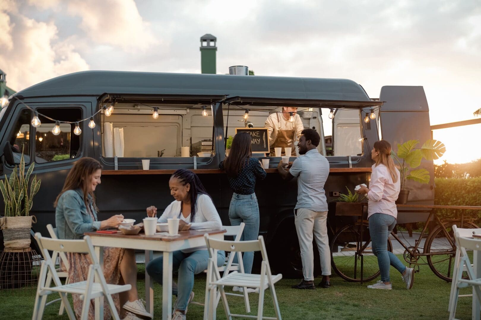 People gathered around a trendy food truck