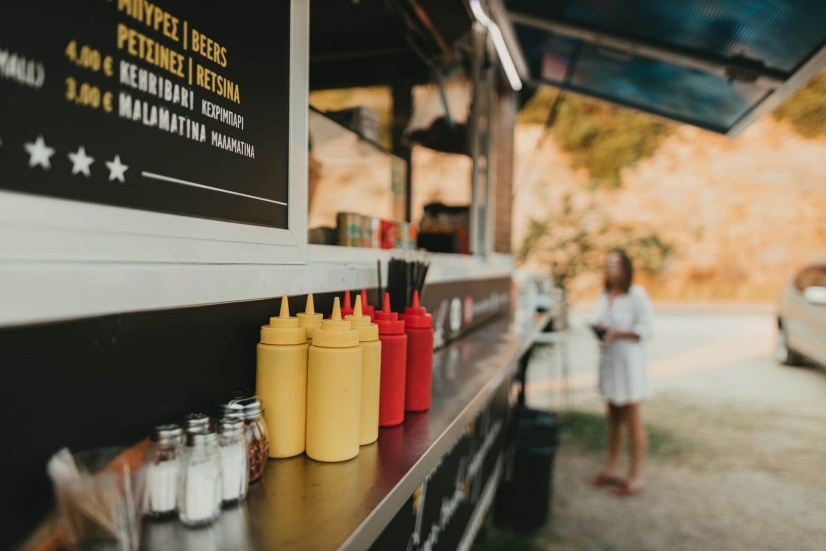 Street food setup with sauces and menu
