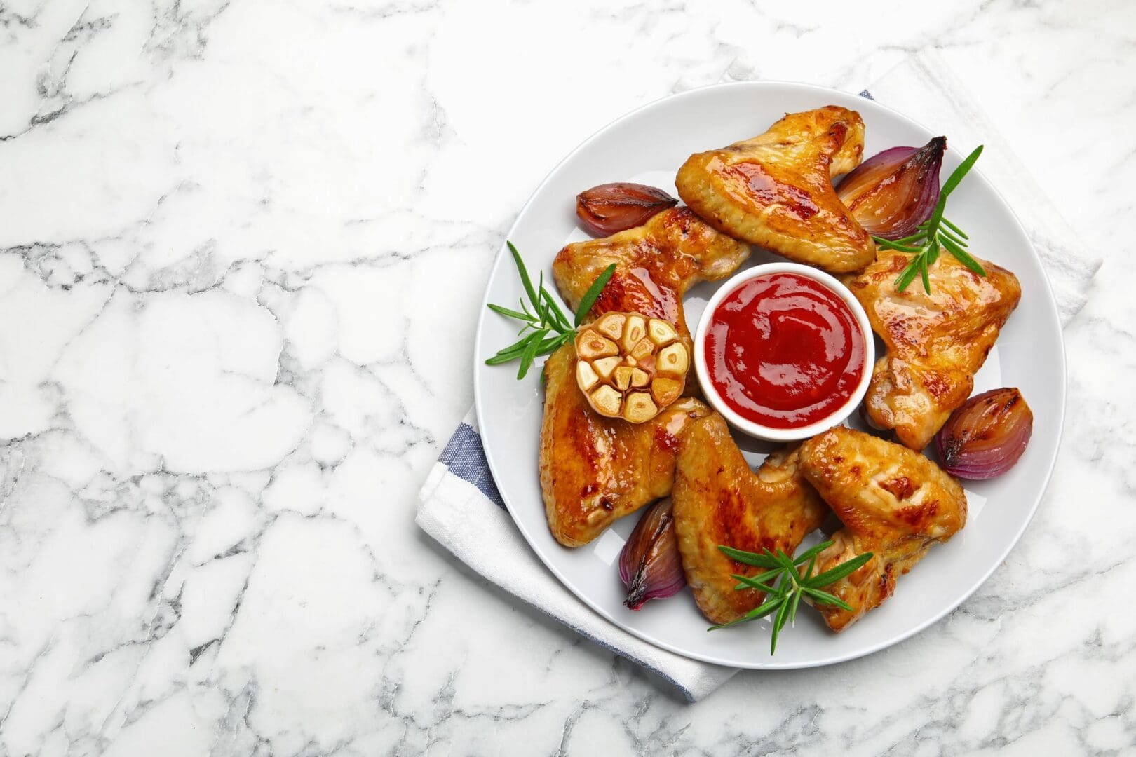 Chicken wings with sauce on white plate