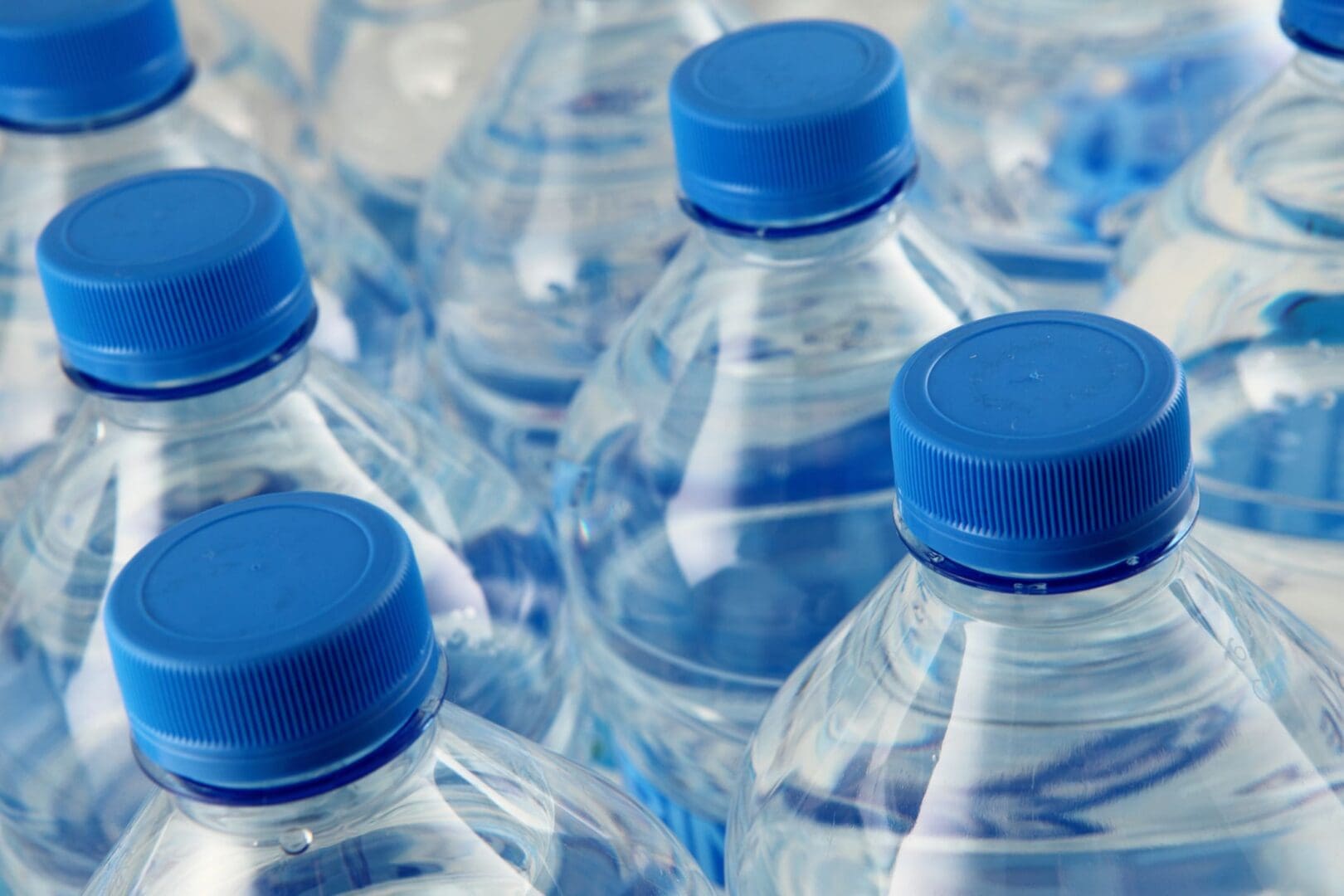 Clear water bottles with blue lids