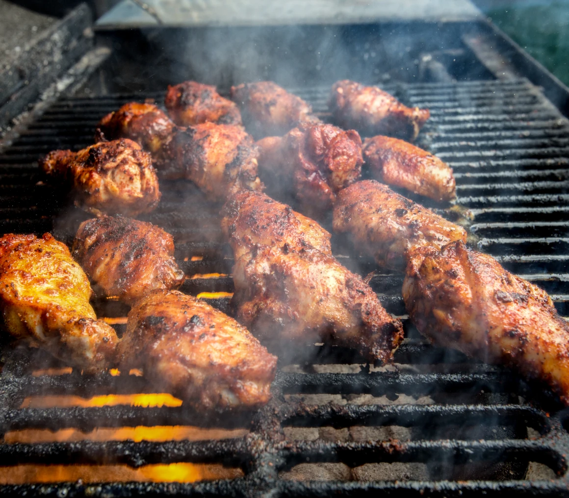 Spicy chicken wings on grill